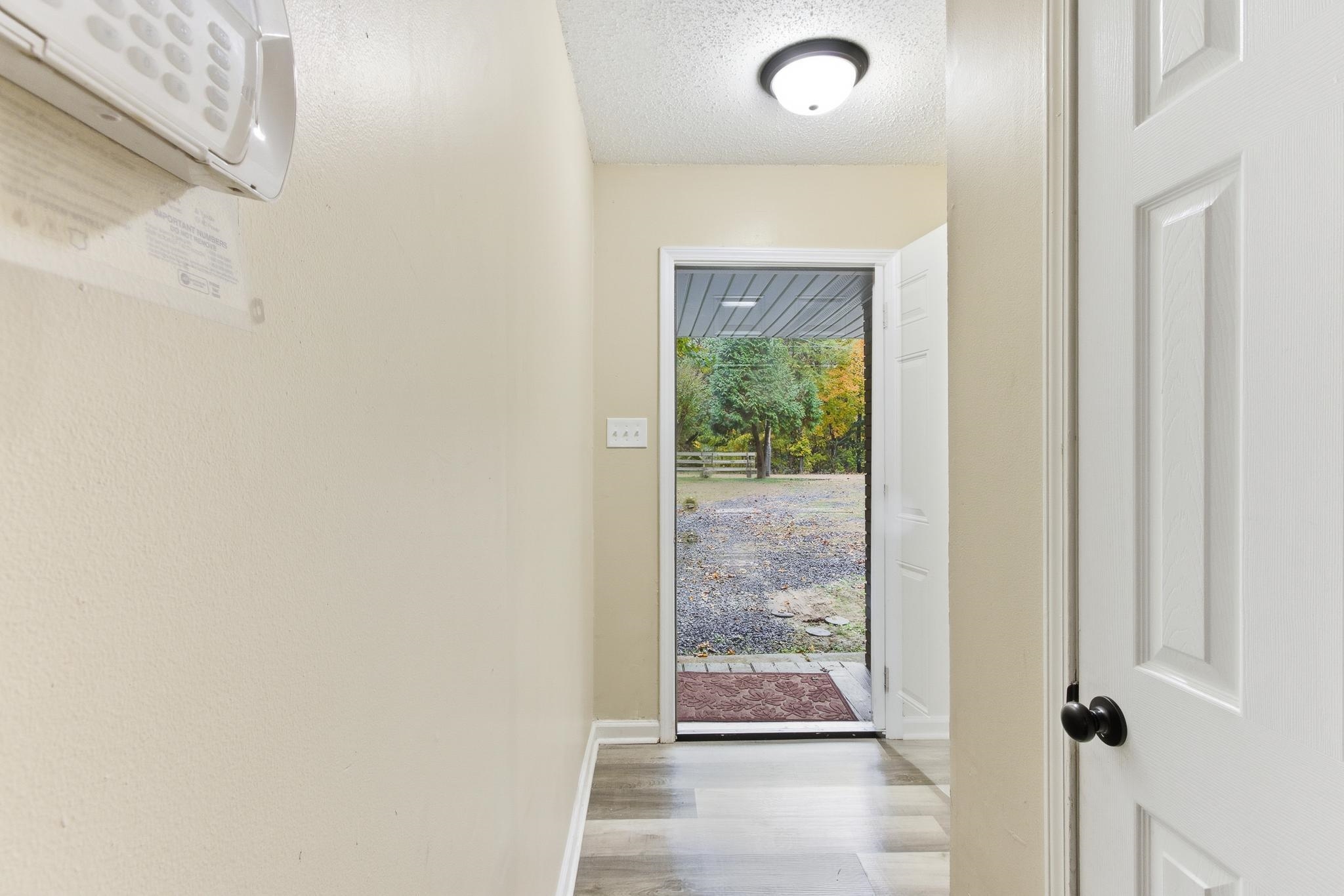 5002 Benjestown Road Memphis, TN 38127 - Photo 5 of 29 Entryway featuring wood finished floors and a textured ceiling