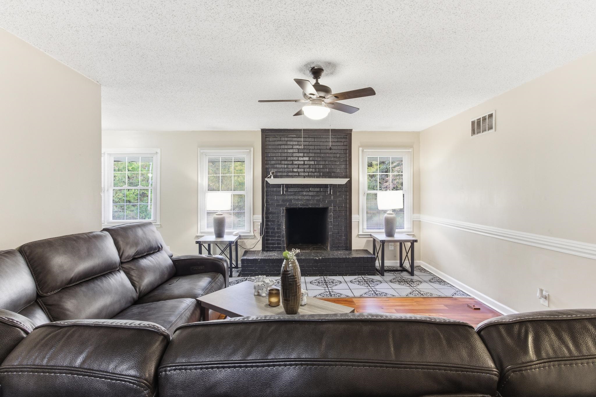 5002 Benjestown Road Memphis, TN 38127 - Photo 7 of 29 Living area with a fireplace, a textured ceiling, and a ceiling fan