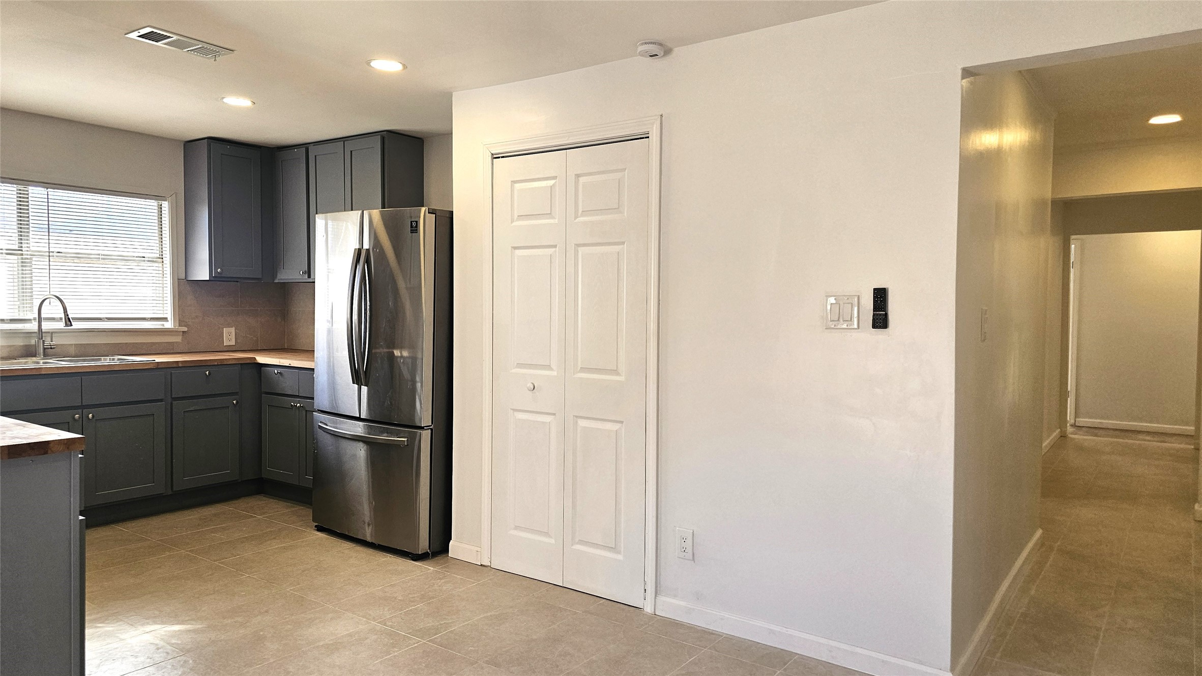 1202 Dyer Avenue, Unit A Rosenberg, TX 77471 - Photo 11 of 14 a kitchen with a refrigerator and a sink