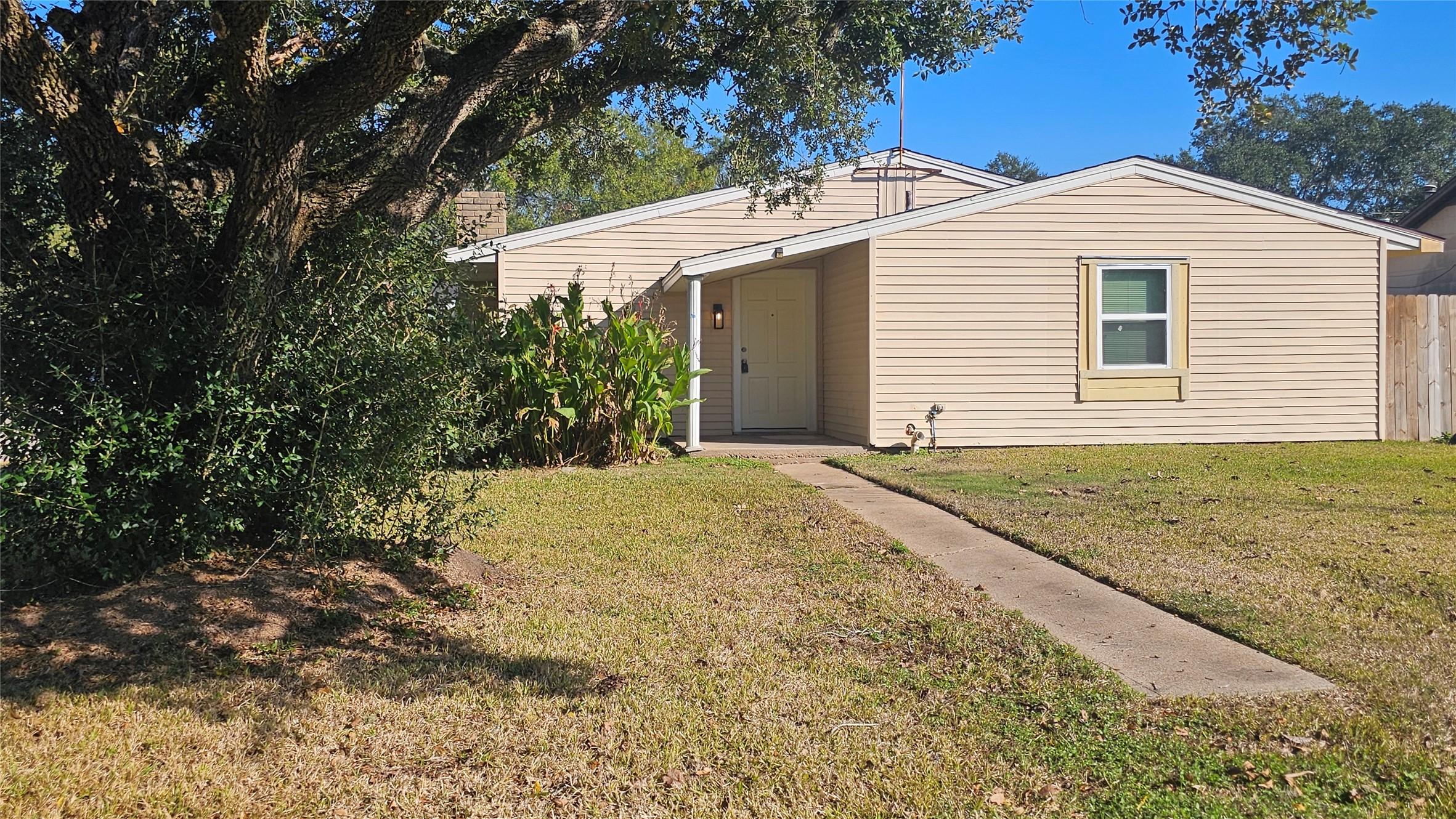 1202 Dyer Avenue, Unit A Rosenberg, TX 77471 - Photo 14 of 14 a front view of a house with a yard and garage