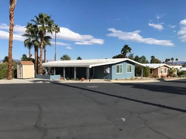 a front view of house with yard and mountain view