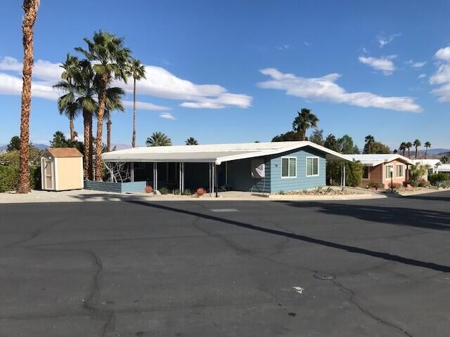 a front view of house with yard and mountain view