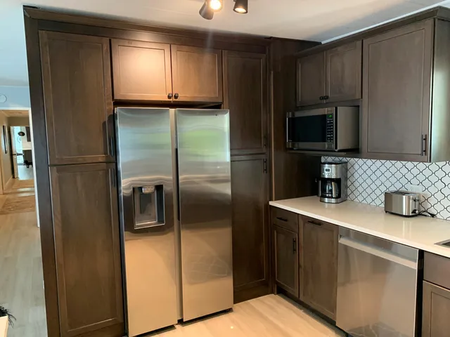 a kitchen with a refrigerator and a sink