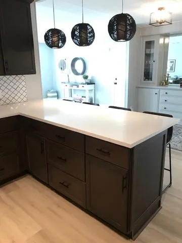 a kitchen with a cabinets and chandelier