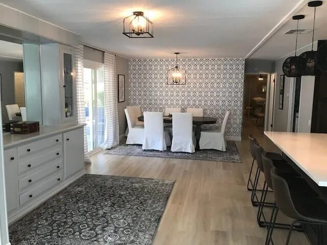 a view of a dining room with furniture and wooden floor