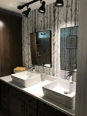 a bathroom with a sink and a mirror