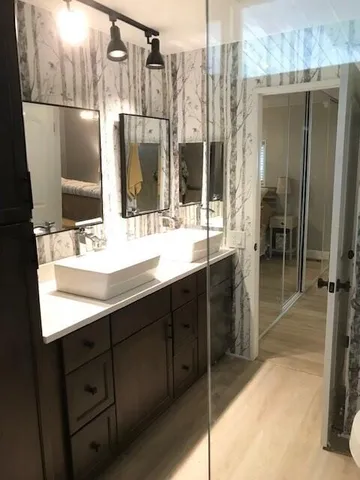 a bathroom with a double vanity sink a and a mirror