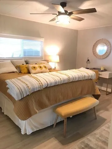 a bed sitting in a bedroom next to a window