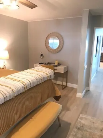 a bedroom with a bed and a lamp