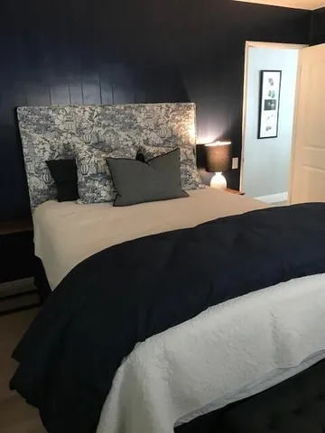 a bedroom with a bed and a night stand