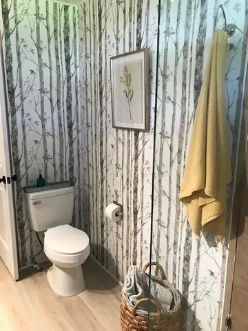 a white toilet sitting next to a shower curtain