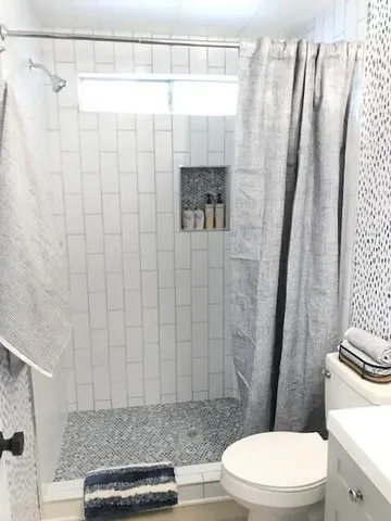 a bathroom with a toilet and shower