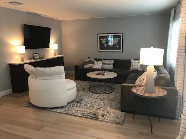 a living room with furniture and a flat screen tv