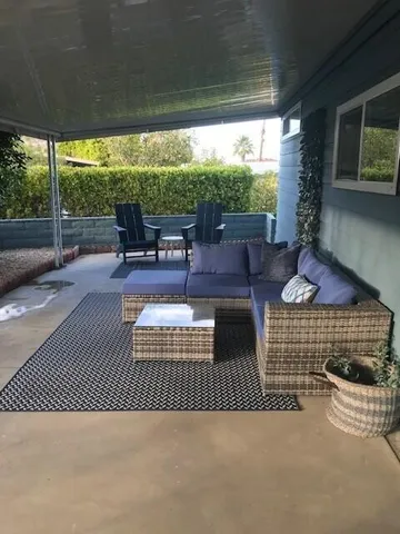 a outdoor space with patio the couches and a dining table with garden view