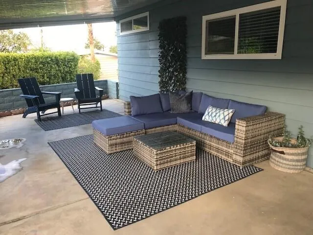 a outdoor living space with furniture and a rug
