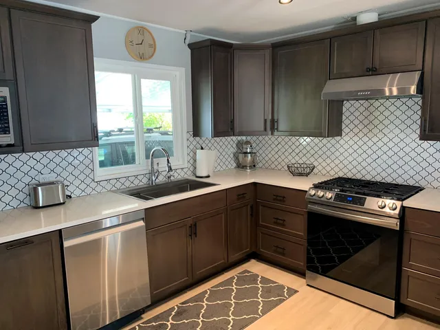 a kitchen with a sink stove and cabinets
