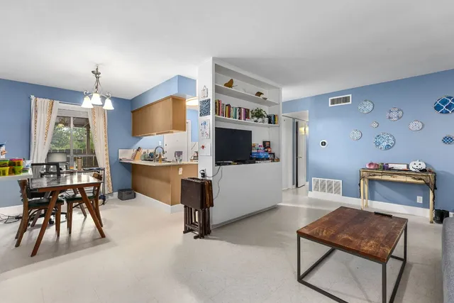 a living room with furniture and flat screen tv