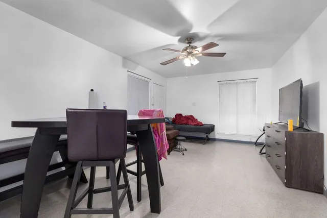 a view of a dining room with furniture and a chandelier