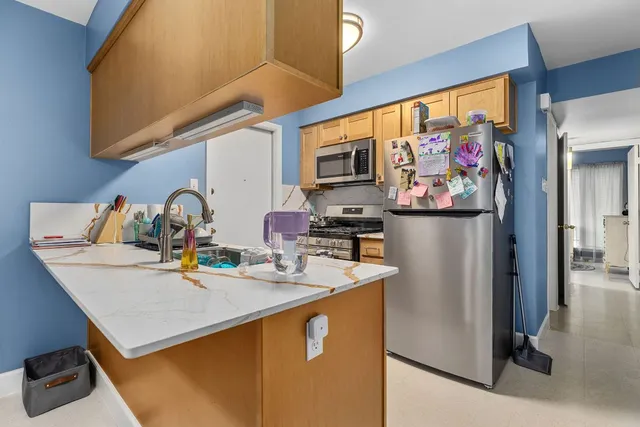 a kitchen with stainless steel appliances a sink a stove and a refrigerator