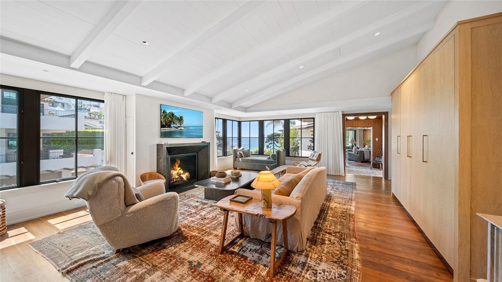27 Emerald Bay Laguna Beach, CA 92651 - Photo 11 of 47 a living room with fireplace furniture and a large window