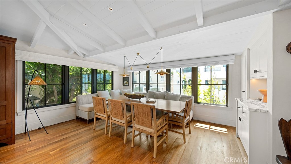 27 Emerald Bay Laguna Beach, CA 92651 - Photo 20 of 47 a dining room with wooden floor glass walls and glass windows