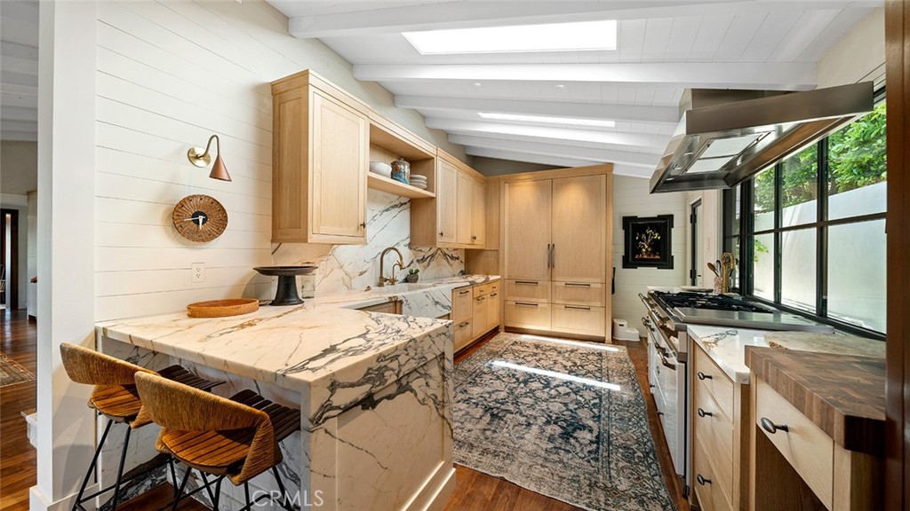 27 Emerald Bay Laguna Beach, CA 92651 - Photo 24 of 47 a kitchen with stainless steel appliances granite countertop a stove a sink dishwasher and a refrigerator with wooden floor