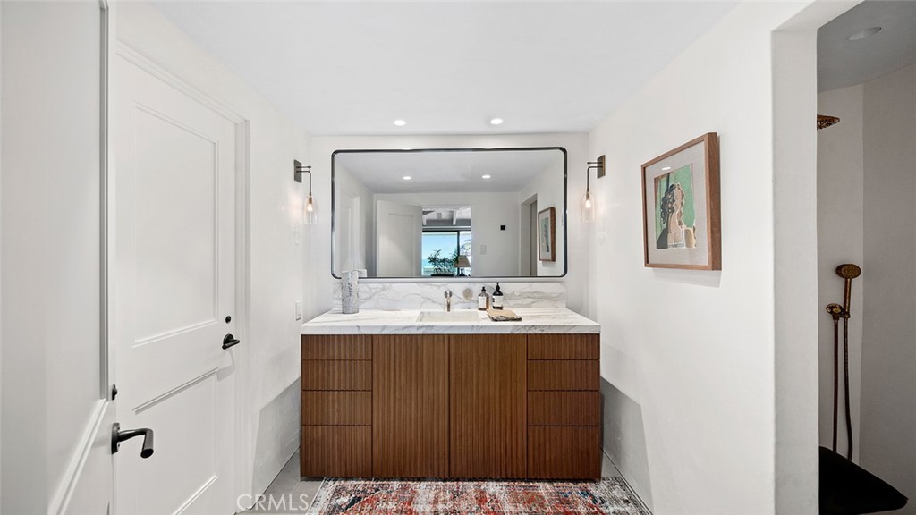 27 Emerald Bay Laguna Beach, CA 92651 - Photo 31 of 47 a bathroom with a sink a mirror and a vanity