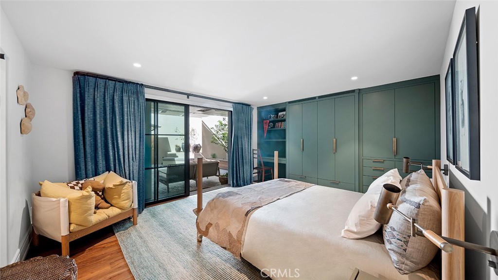 27 Emerald Bay Laguna Beach, CA 92651 - Photo 32 of 47 a bedroom with a bed and glass window