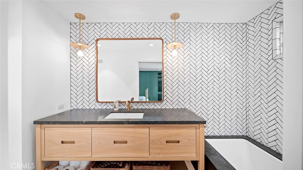 27 Emerald Bay Laguna Beach, CA 92651 - Photo 33 of 47 a bathroom with a sink and a mirror