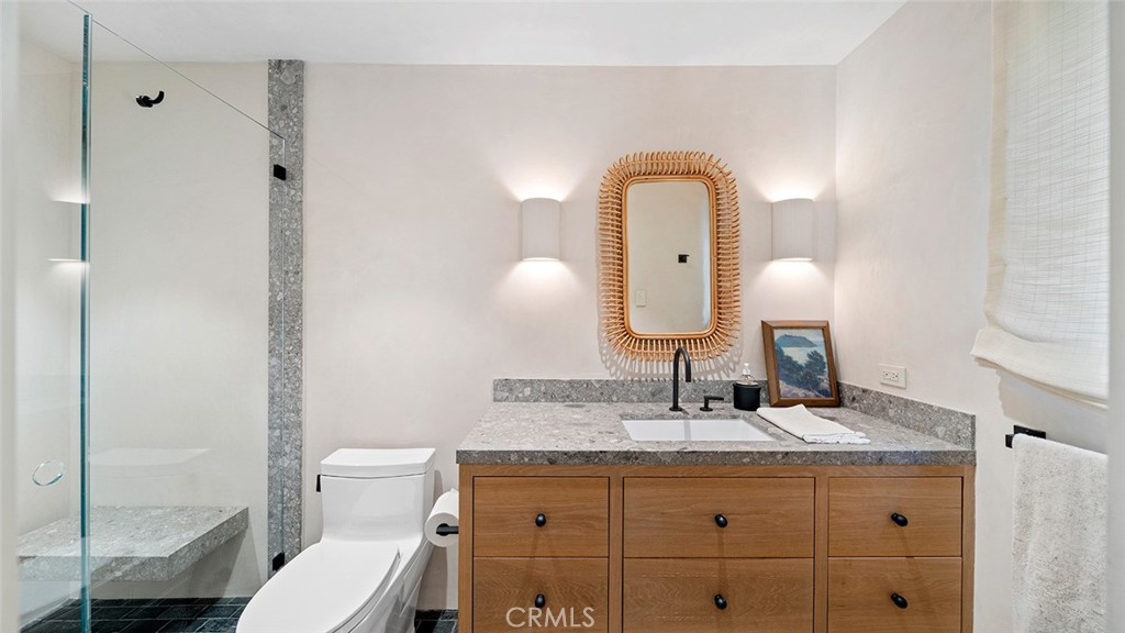 27 Emerald Bay Laguna Beach, CA 92651 - Photo 39 of 47 a bathroom with a toilet sink and mirror