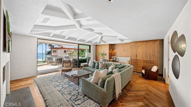 a living room with furniture a wooden floor and a large window