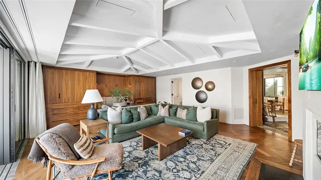 a living room with furniture fireplace and a large window