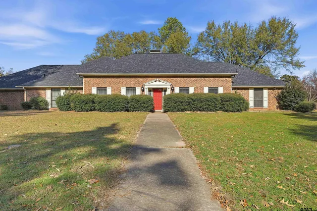 a view of house with a yard