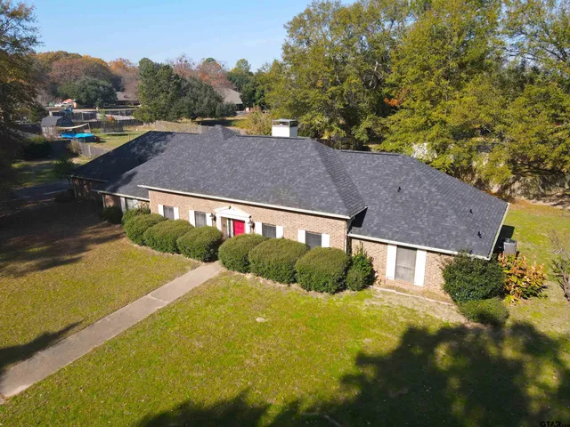 a view of a house with yard and sitting area