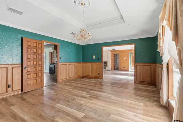 a view of a livingroom with wooden floor and a ceiling fan