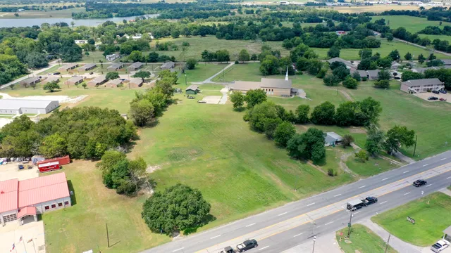 an aerial view of residential houses with outdoor space and street view