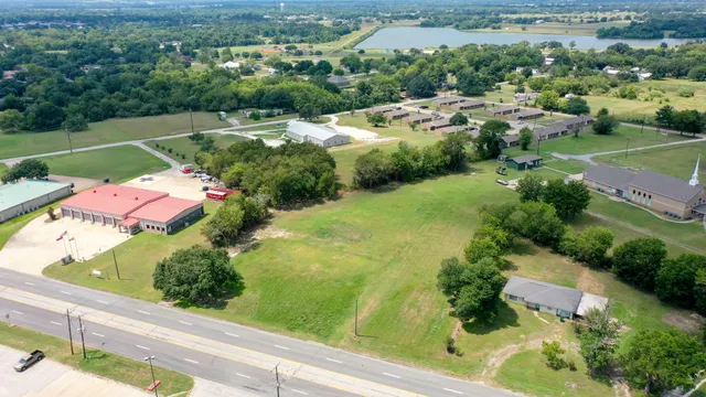 an aerial view of residential houses with outdoor space and street view