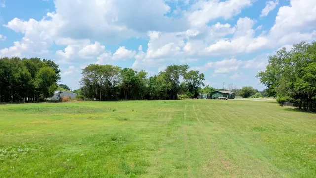 a view of field with trees in the background