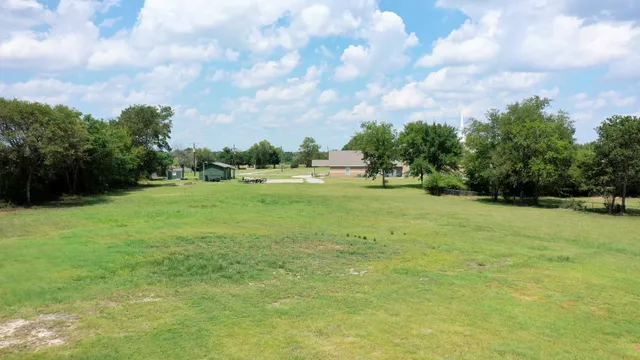 a view of grassy field with trees