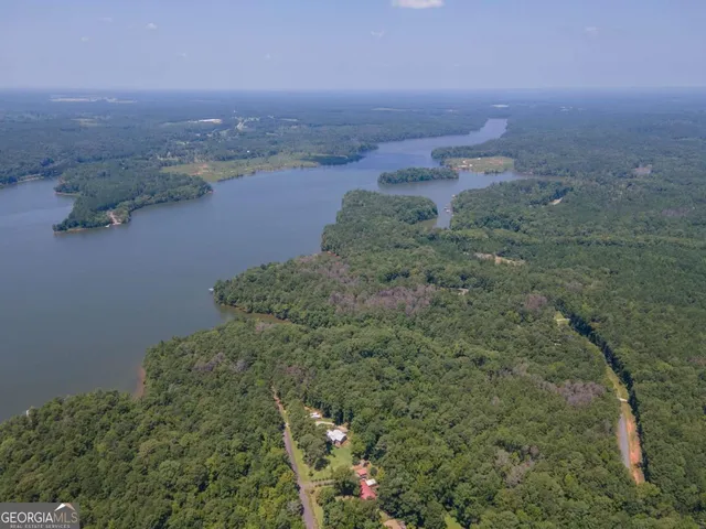 an aerial view of a houses with yard