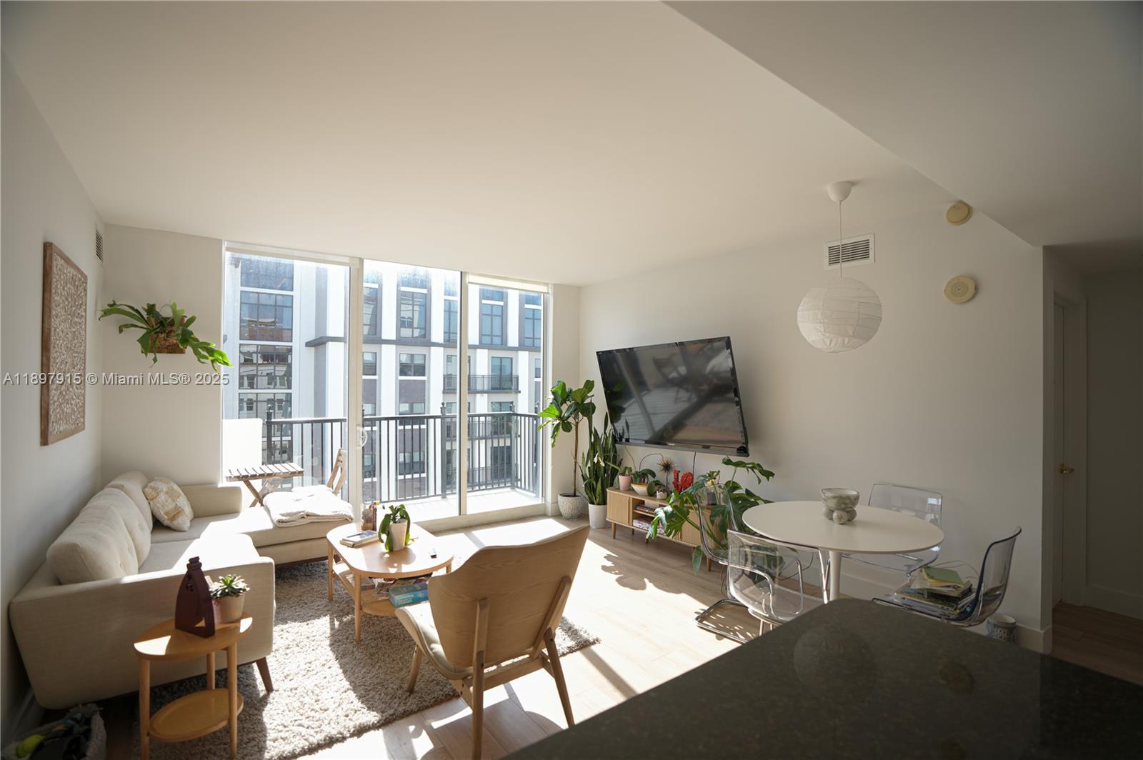 4100 Salzedo Street, Unit 916 Coral Gables, FL 33146 - Photo 1 of 24 a living room with furniture and a flat screen tv