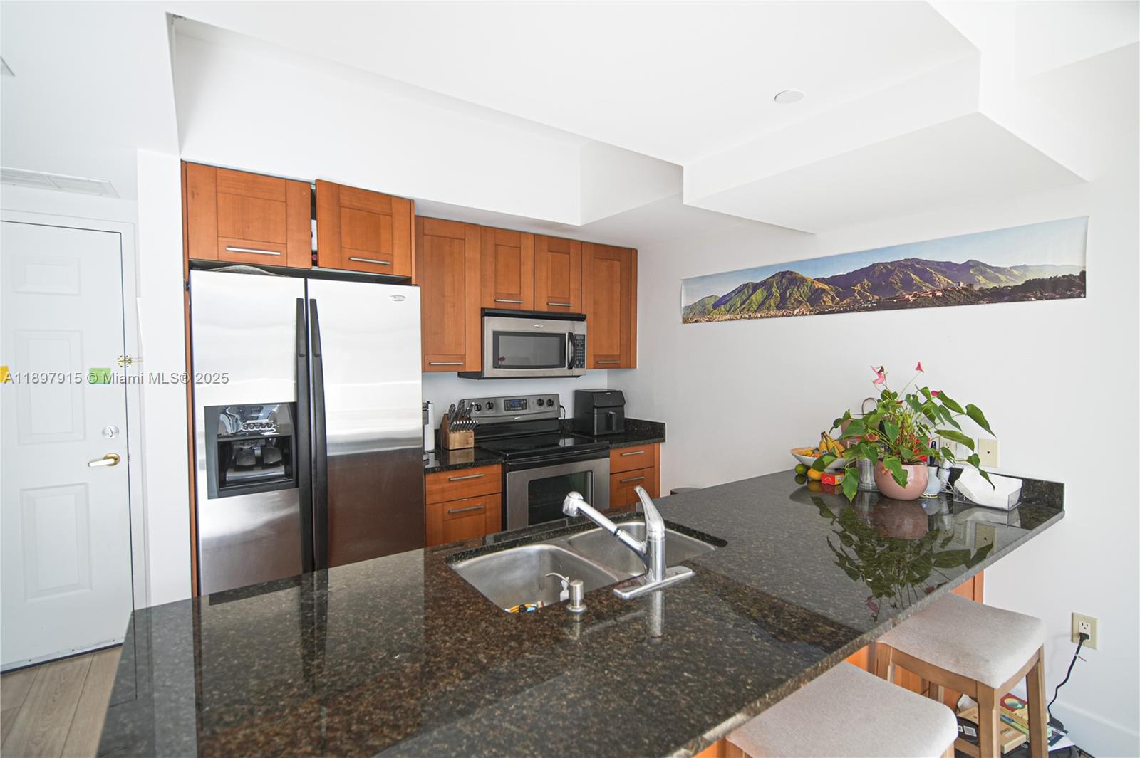 4100 Salzedo Street, Unit 916 Coral Gables, FL 33146 - Photo 4 of 24 a kitchen with stainless steel appliances granite countertop a refrigerator and a stove