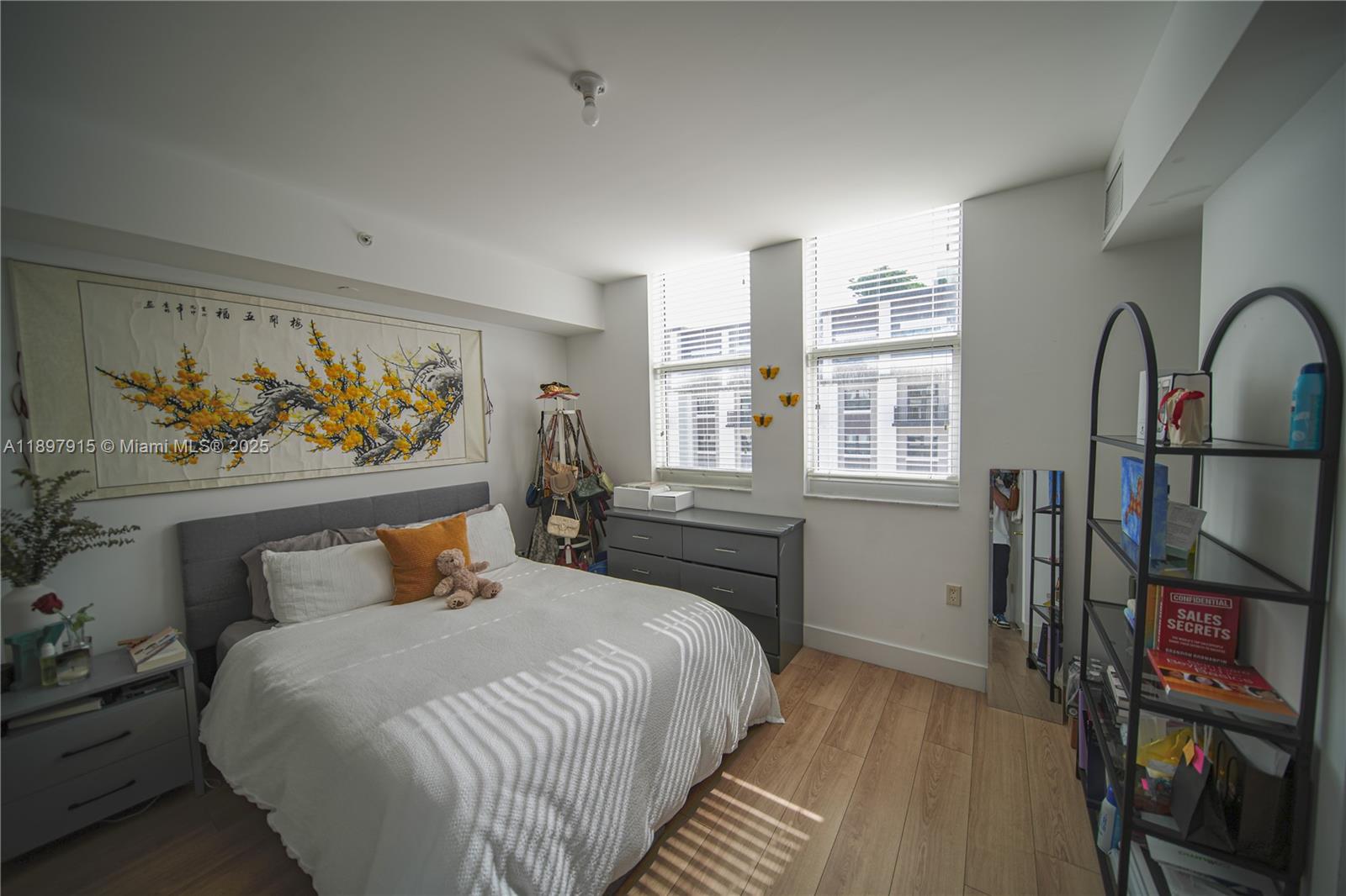 4100 Salzedo Street, Unit 916 Coral Gables, FL 33146 - Photo 7 of 24 a bedroom with a bed a dresser and book shelf