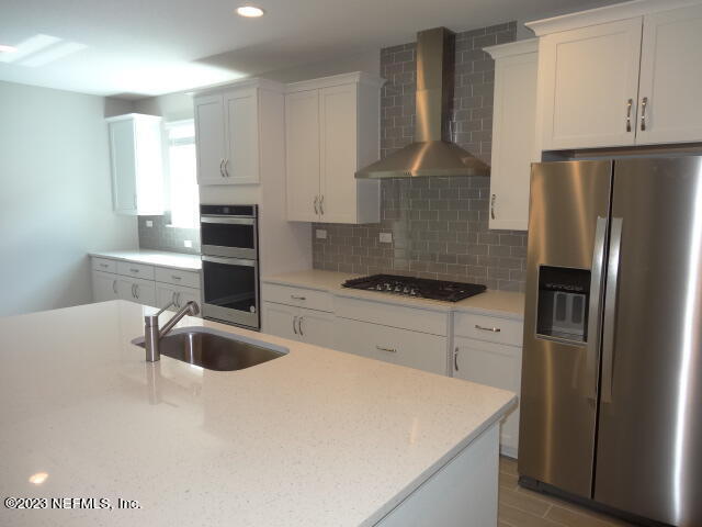 69 Trewin Circle St. Augustine, FL 32092 - Photo 11 of 36 a kitchen with stainless steel appliances a refrigerator sink and stove