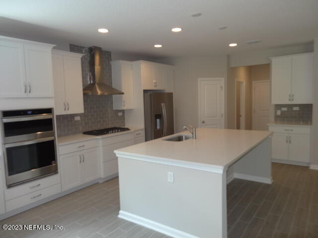 69 Trewin Circle St. Augustine, FL 32092 - Photo 13 of 36 a kitchen with a sink a stove and refrigerator