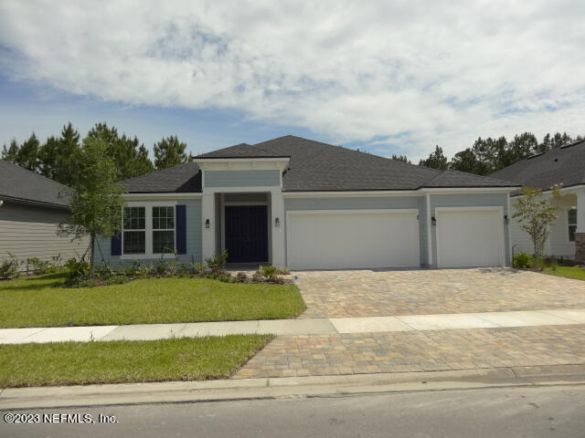 69 Trewin Circle St. Augustine, FL 32092 - Photo 2 of 36 a front view of a house with a garden