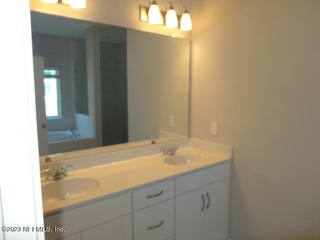 69 Trewin Circle St. Augustine, FL 32092 - Photo 22 of 36 a bathroom with a sink and a mirror