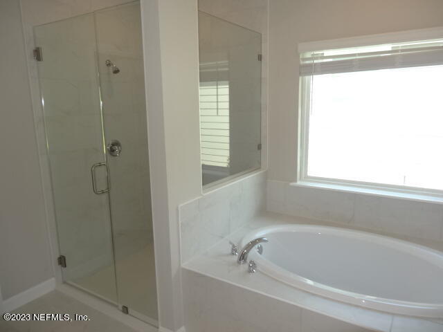 69 Trewin Circle St. Augustine, FL 32092 - Photo 23 of 36 a white bath tub sitting next to a window
