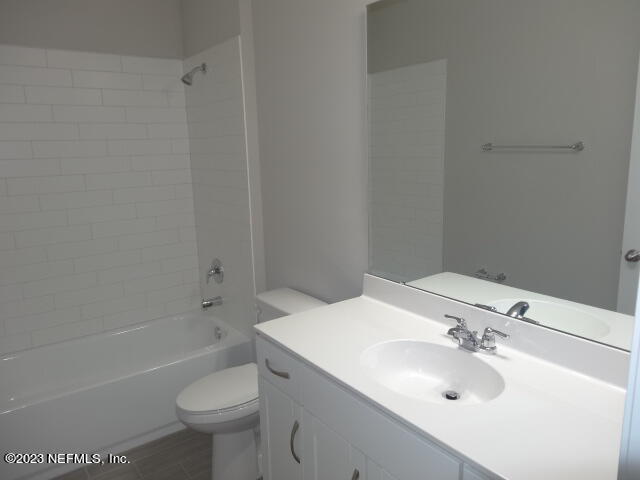 69 Trewin Circle St. Augustine, FL 32092 - Photo 25 of 36 a bathroom with a sink toilet vanity and bathtub