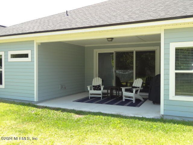 69 Trewin Circle St. Augustine, FL 32092 - Photo 33 of 36 a balcony with table and chairs and potted plants